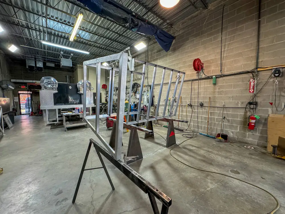 Diamond-plate body and step detail in production, photo 168 of 303.